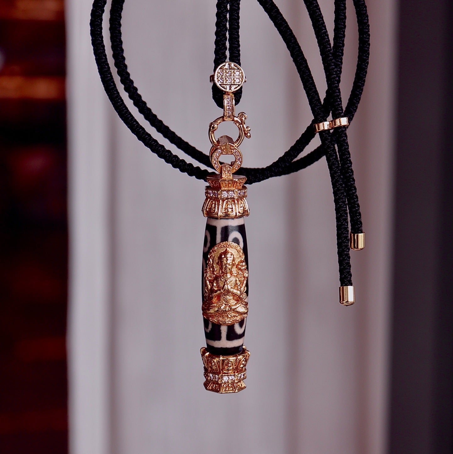 Tibetan Dzi bead pendant necklace with gold details, handcrafted spiritual jewelry
