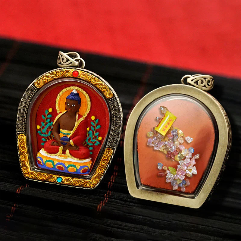 Comparison of Tibetan Thangka pendants for wealth and healing, featuring Jambhala and Medicine Buddha designs.