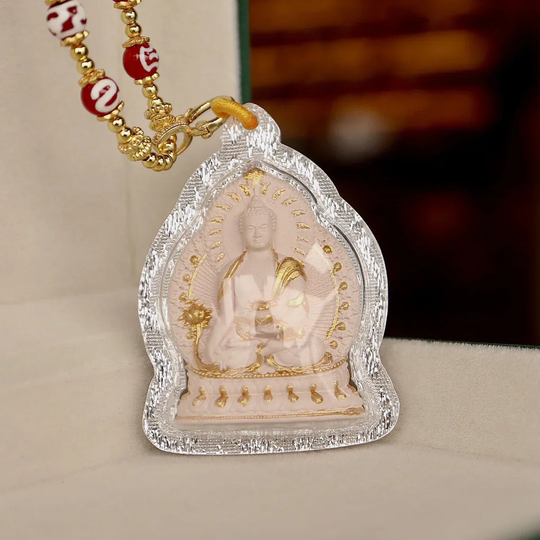Hand-painted Medicine Buddha Thangka pendant with Dzi bead necklace, lotus base, and Tibetan spiritual craftsmanship.