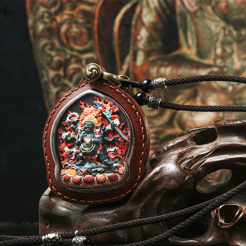 Handcrafted Tibetan Tsatsa Thangka pendant with wrathful deity, detailed relief carving and leather frame