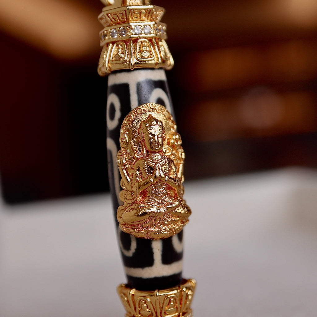Nine eyed Tibetan dzi bead pendant with Four-Armed Chenrezig for protection and prosperity
