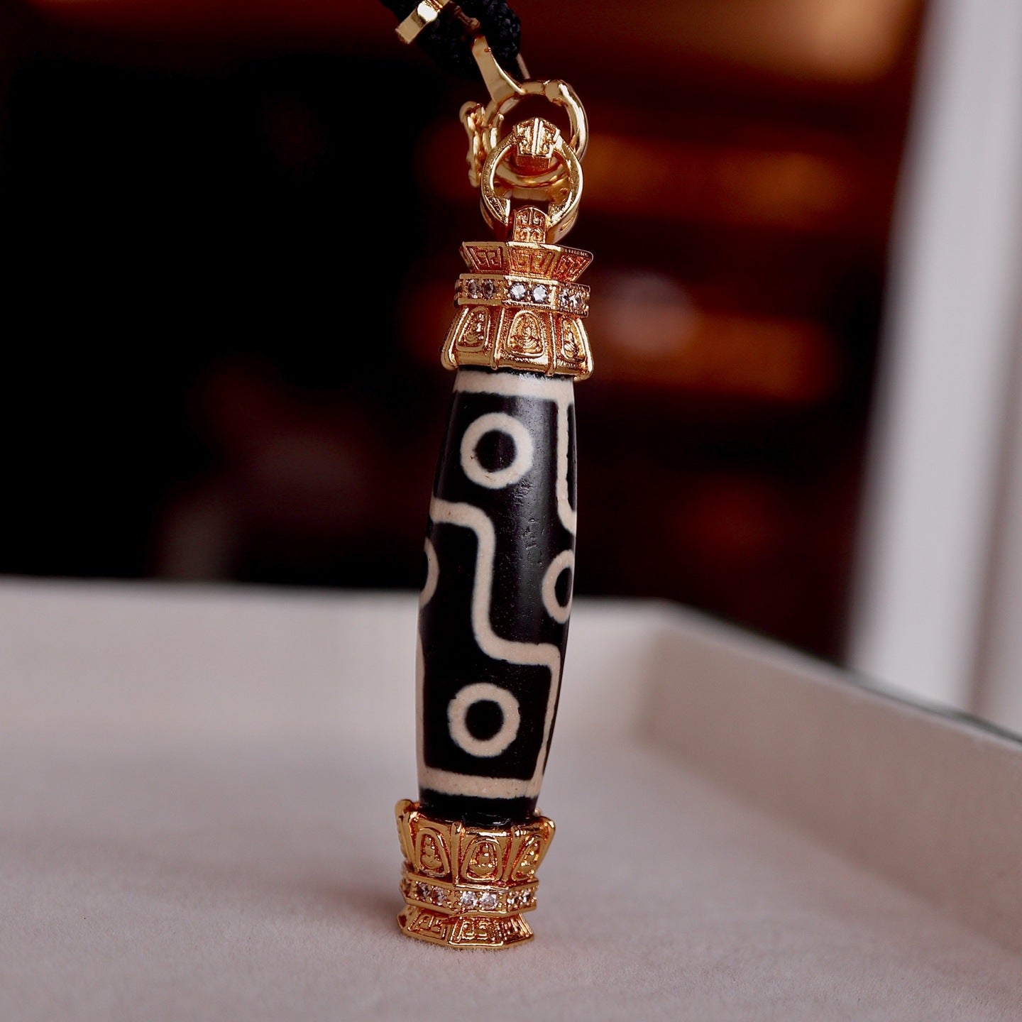 Close-up of sacred 9-eyed dzi bead texture on Aurafeng necklace