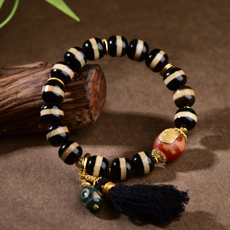 Close-up of natural agate dzi bead texture and 925 silver inlay details
