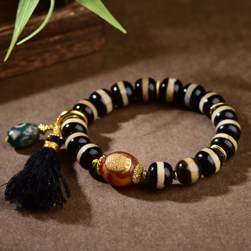 Tibetan dzi bead bracelet styled for yoga and meditation practice