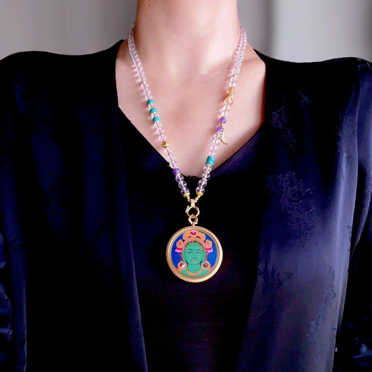Green Tara pendant worn as Buddhist spiritual amulet