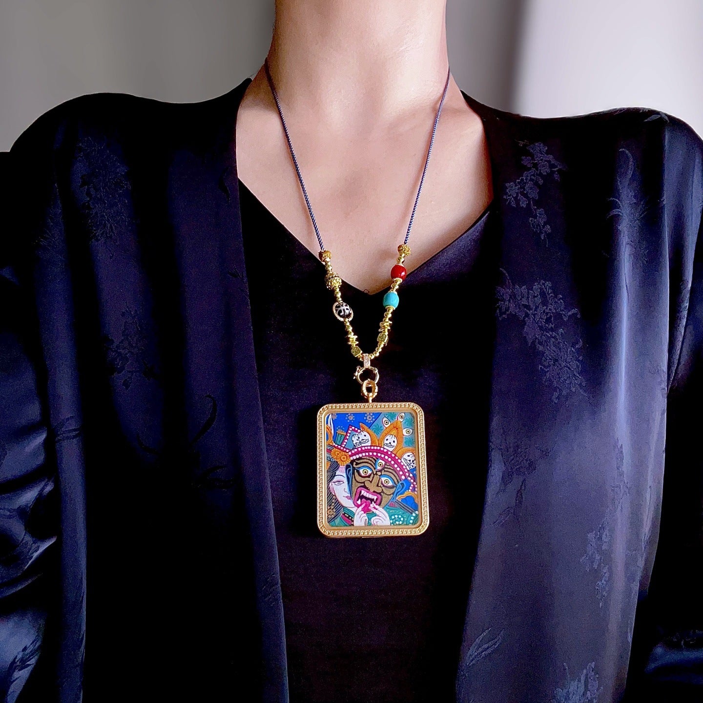 Green Tara pendant worn as Buddhist spiritual amulet