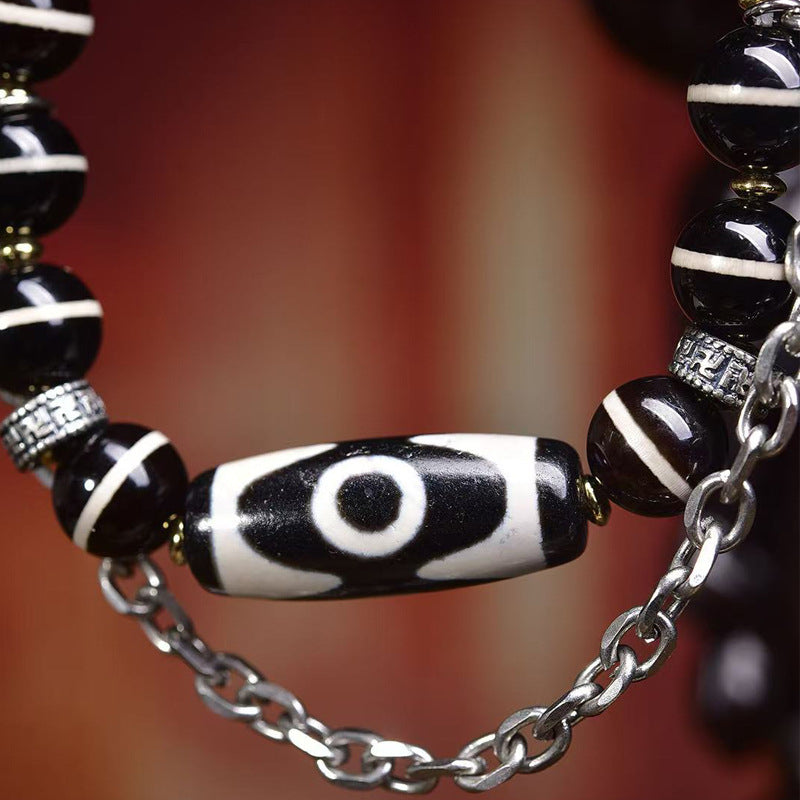 Detailed view of three-eye dzi bead on Aurafeng vintage Tibetan bracelet
