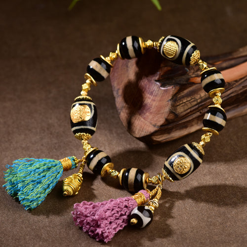 Close-up of natural tiger tooth dzi bead texture and 925 silver accents
