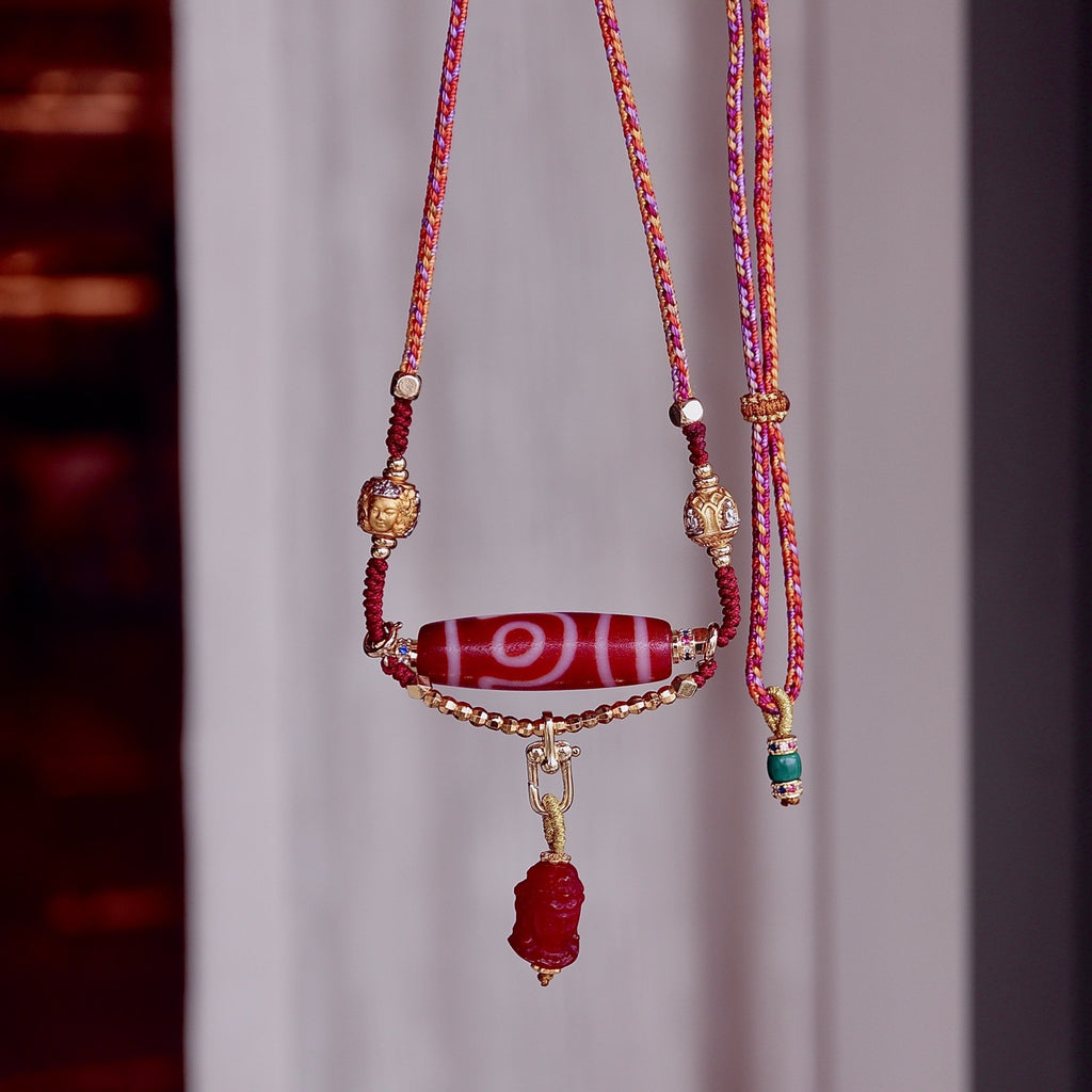 Two eyed Tibetan dzi bead pendant symbolizing wealth and protection